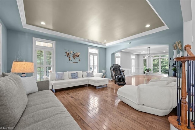 8501 Julina Dr, Oak Ridge, NC 27310 - living room featuring a raised ceiling, arched walkways, hardwood / wood-style flooring, crown molding, and recessed lighting