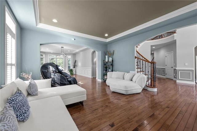 8501 Julina Dr, Oak Ridge, NC 27310 - living area featuring arched walkways, a decorative wall, a raised ceiling, wood-type flooring, and stairs