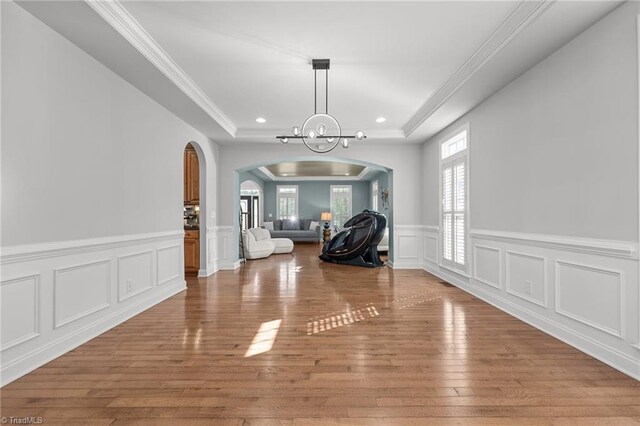 8501 Julina Dr, Oak Ridge, NC 27310 - unfurnished dining area with arched walkways, a raised ceiling, a chandelier, recessed lighting, and a wainscoted wall