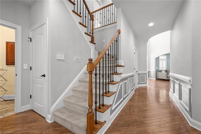 8501 Julina Dr, Oak Ridge, NC 27310 - stairway featuring hardwood / wood-style flooring, arched walkways, and recessed lighting