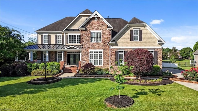 8501 Julina Dr, Oak Ridge, NC 27310 - craftsman house featuring stone siding, a standing seam roof, and covered porch