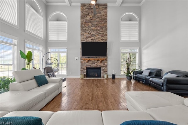 8501 Julina Dr, Oak Ridge, NC 27310 - living room with a high ceiling, a stone fireplace, wood-type flooring, beamed ceiling, and baseboards