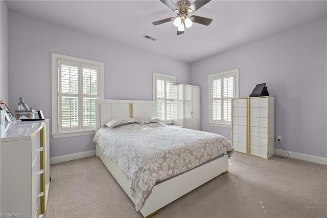 8501 Julina Dr, Oak Ridge, NC 27310 - bedroom featuring light carpet, baseboards, and a ceiling fan