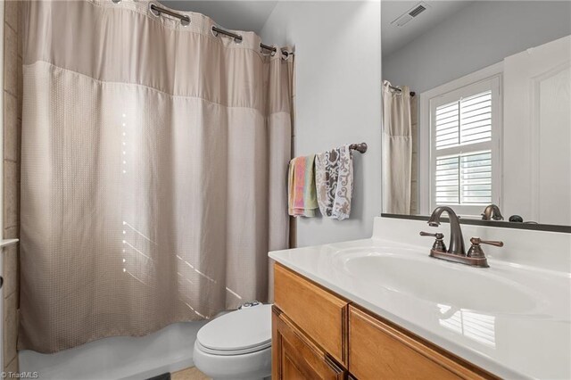 8501 Julina Dr, Oak Ridge, NC 27310 - full bath featuring toilet, shower / bath combo, and vanity