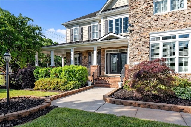 8501 Julina Dr, Oak Ridge, NC 27310 - entrance to property with a porch and stone siding