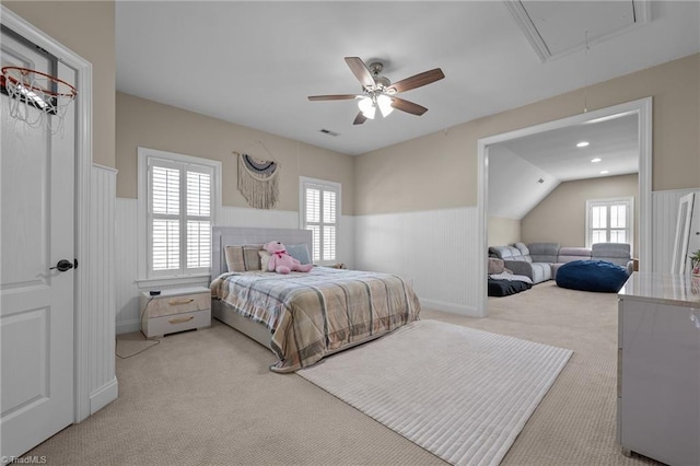 8501 Julina Dr, Oak Ridge, NC 27310 - carpeted bedroom with attic access, a wainscoted wall, multiple windows, and a ceiling fan