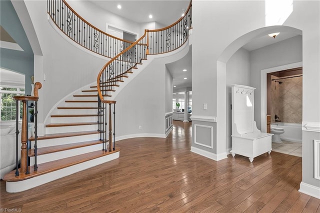 8501 Julina Dr, Oak Ridge, NC 27310 - entryway with plenty of natural light, a high ceiling, arched walkways, hardwood / wood-style flooring, and stairs