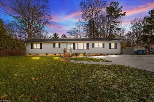 single story home featuring a yard and an outbuilding