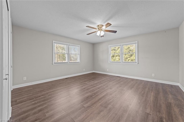 spare room with dark wood-type flooring, a textured ceiling, and ceiling fan