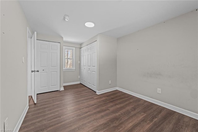 unfurnished bedroom featuring dark hardwood / wood-style floors