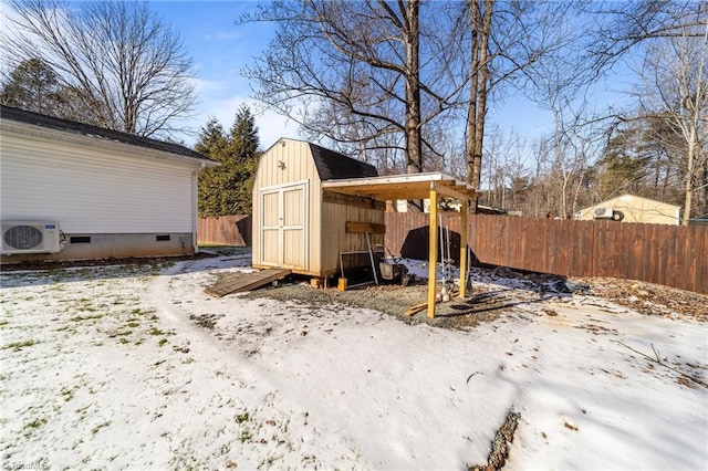 snow covered structure with ac unit