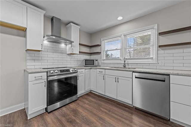 kitchen featuring stainless steel appliances, sink, white cabinets, wall chimney exhaust hood, and dark wood-type flooring