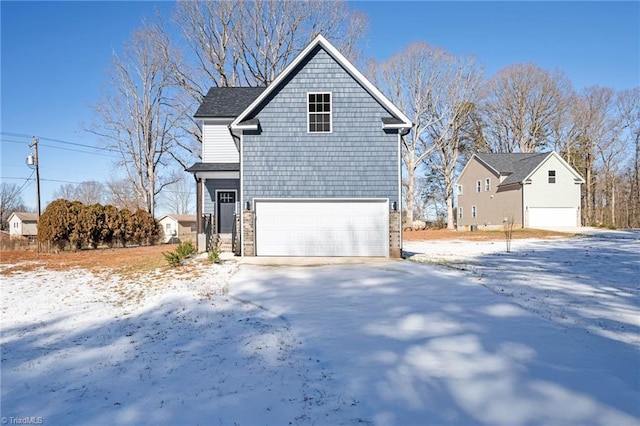 view of snowy exterior with a garage