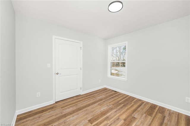 spare room with hardwood / wood-style floors