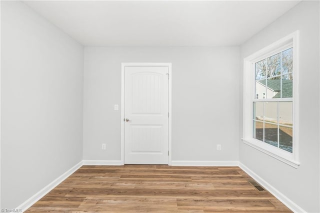 spare room with hardwood / wood-style flooring