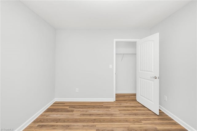 unfurnished bedroom featuring a closet and light hardwood / wood-style flooring