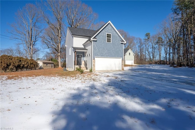 view of snowy exterior with a garage