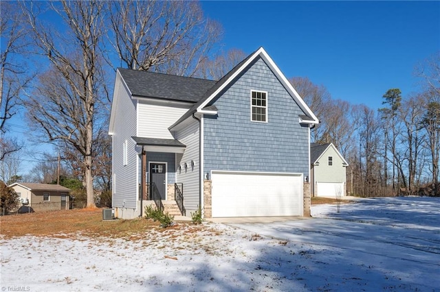 front of property featuring a garage and central AC unit