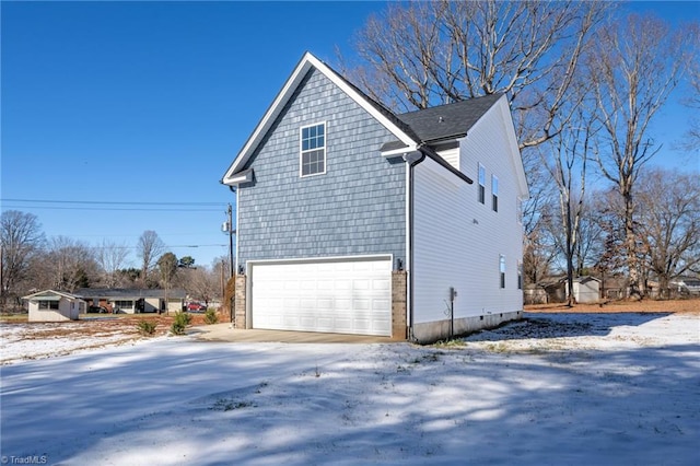 view of snowy exterior with a garage