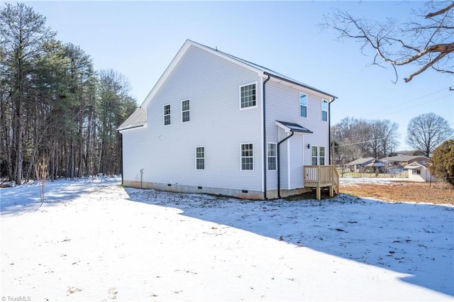 view of snow covered back of property