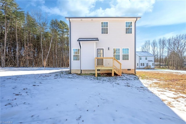 view of snow covered rear of property