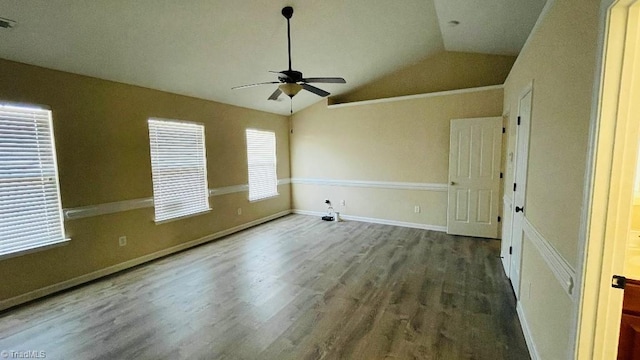 unfurnished room featuring dark hardwood / wood-style floors, vaulted ceiling, and ceiling fan