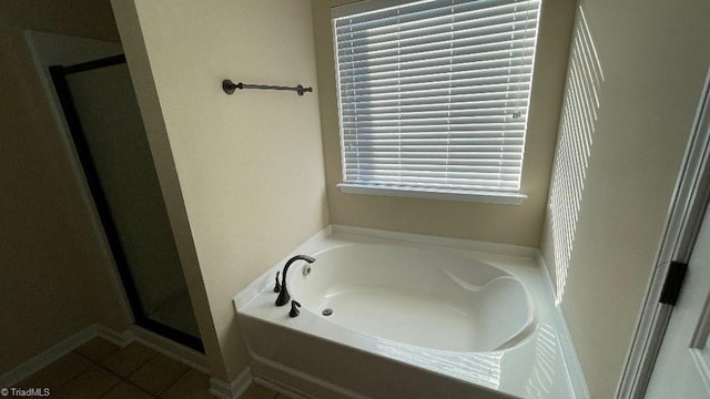 bathroom featuring tile patterned flooring and separate shower and tub