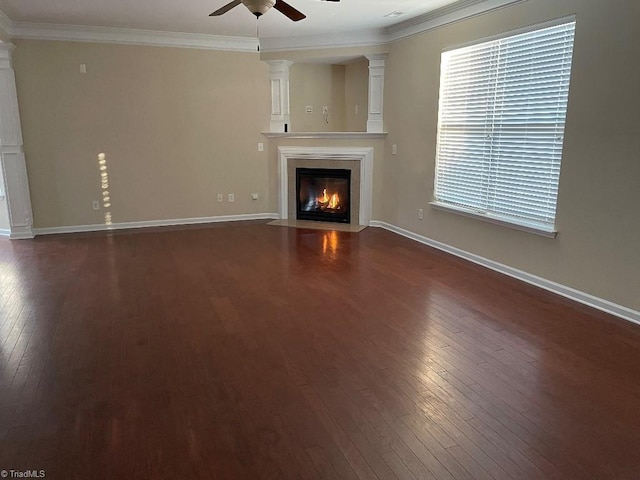 unfurnished living room with ceiling fan, dark hardwood / wood-style floors, and ornamental molding