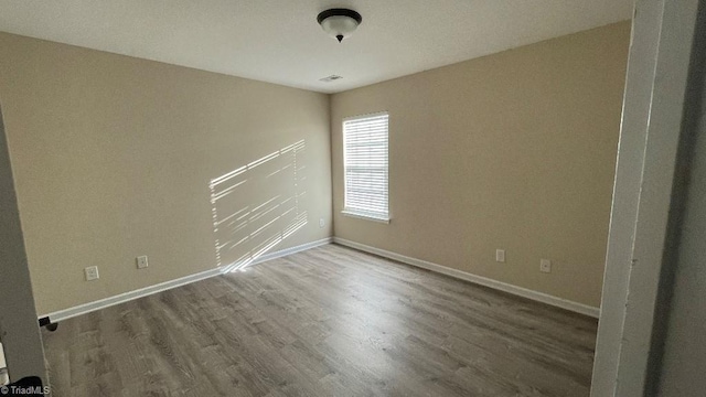 empty room with hardwood / wood-style floors