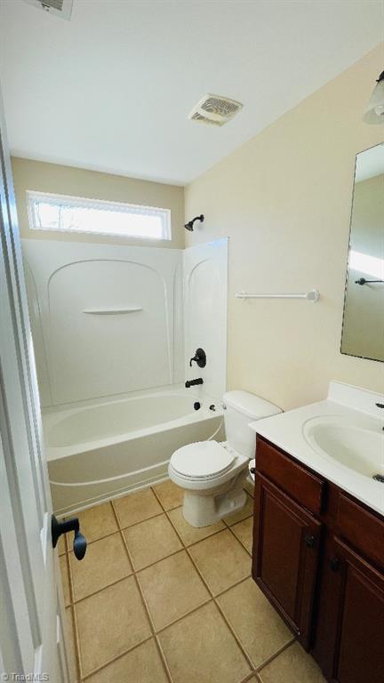 full bathroom featuring tile patterned floors, vanity, toilet, and shower / bathing tub combination