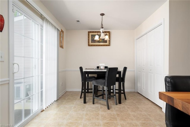 dining room with visible vents, baseboards, and a chandelier