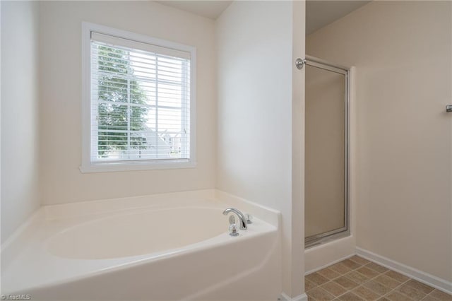 full bathroom featuring a bath and a stall shower