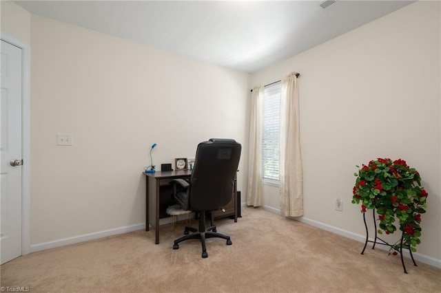 carpeted office space featuring baseboards
