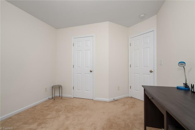 office area with baseboards and light carpet