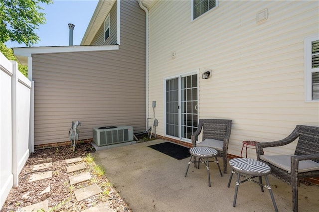 view of patio / terrace featuring central air condition unit and fence