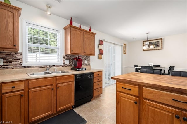 kitchen with decorative backsplash, wooden counters, a sink, and dishwasher