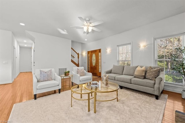living room featuring stairs, recessed lighting, ceiling fan, light wood-style flooring, and visible vents