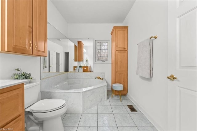 full bath featuring visible vents, toilet, vanity, a garden tub, and tile patterned flooring