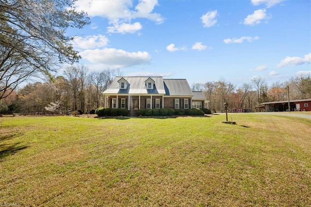 view of front of home featuring a front lawn and metal roof