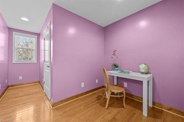 office space with baseboards and light wood finished floors