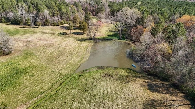 drone / aerial view with a wooded view