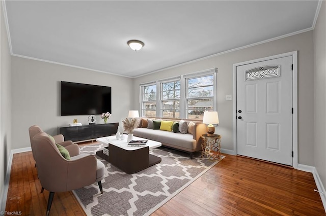 living room with wood-type flooring and ornamental molding