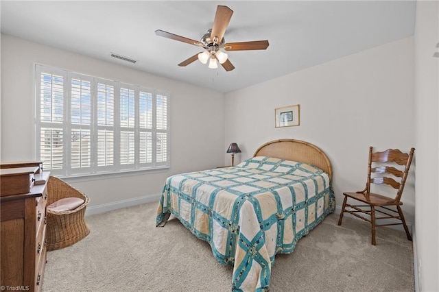 carpeted bedroom featuring visible vents, a ceiling fan, and baseboards