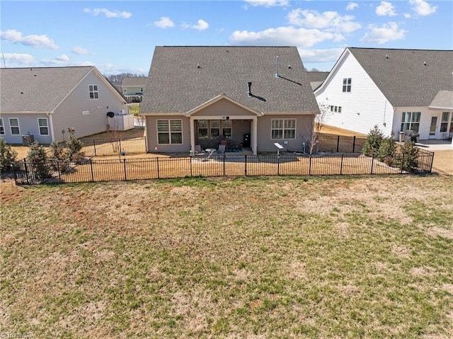 rear view of property featuring fence, a lawn, and a patio area