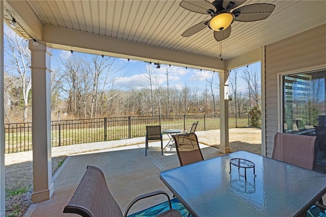 view of patio with a fenced backyard, outdoor dining space, and a ceiling fan