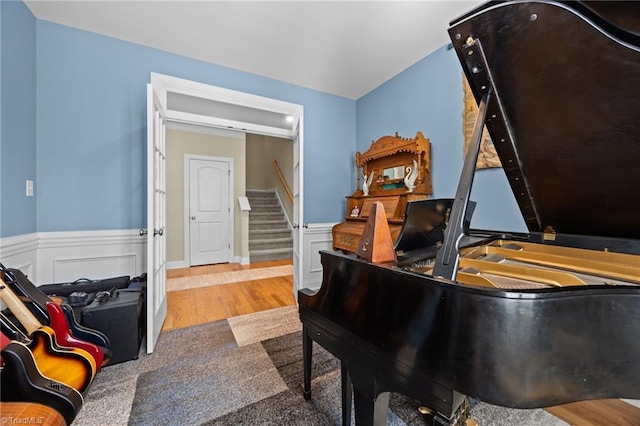 interior space featuring wood finished floors and a wainscoted wall