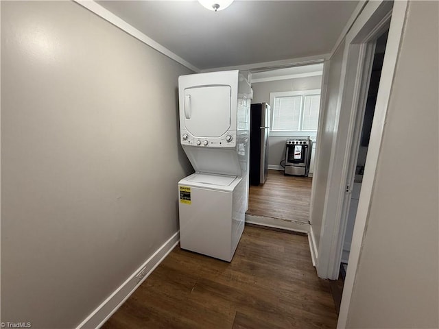 clothes washing area featuring stacked washer and dryer, ornamental molding, and dark hardwood / wood-style floors