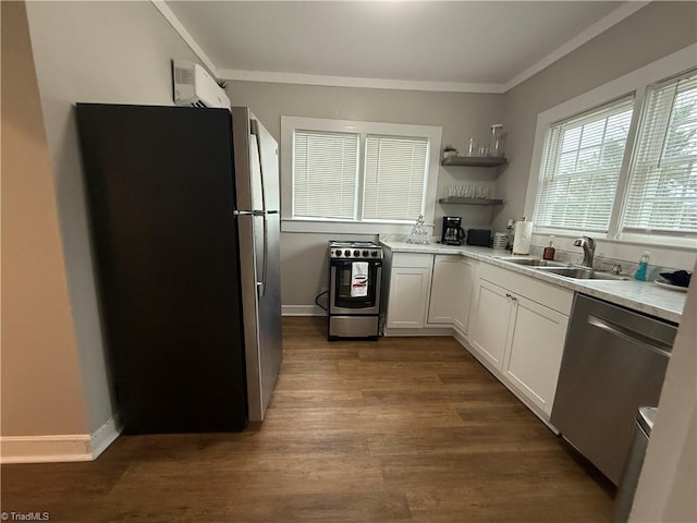 kitchen featuring appliances with stainless steel finishes, dark hardwood / wood-style floors, sink, white cabinets, and ornamental molding