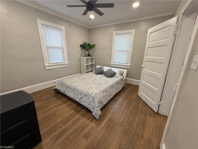 bedroom featuring dark wood-type flooring, ceiling fan, and crown molding