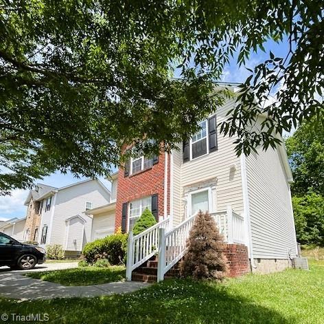 view of front facade with crawl space and a front lawn